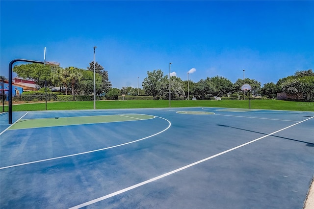 view of sport court featuring a lawn