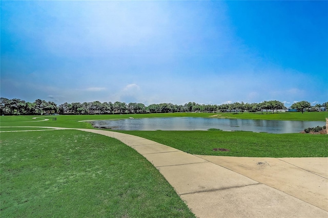 view of home's community featuring a water view and a lawn