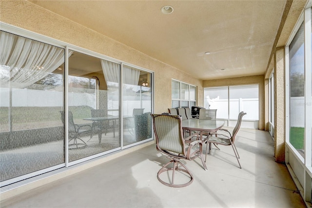 3995 SW 57th Ct, Ocala, FL 34474 - sunroom / solarium with finished concrete floors, outdoor dining area, healthy amount of natural light, and a textured wall