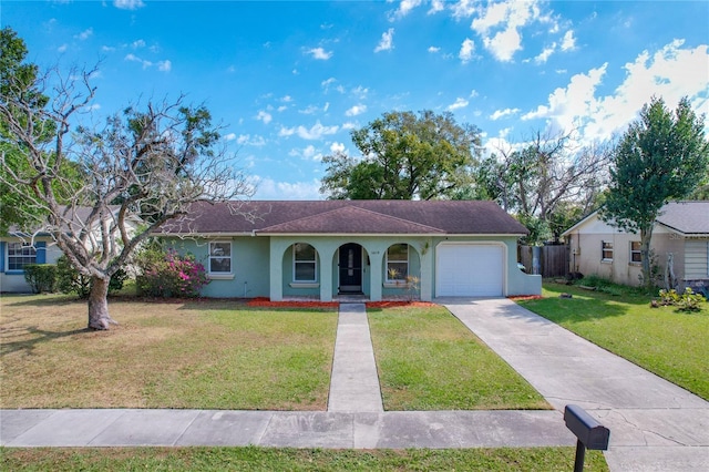 ranch-style home featuring a garage and a front lawn