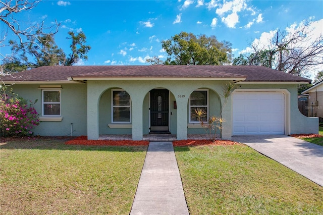 single story home featuring a garage and a front lawn