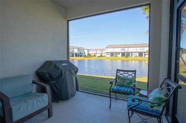 sunroom / solarium featuring a water view