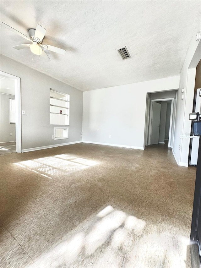 spare room with ceiling fan and a textured ceiling