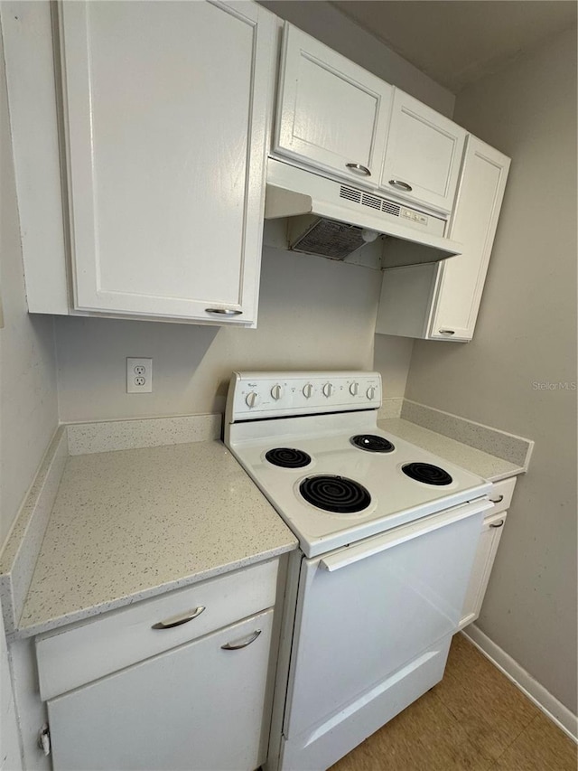 kitchen featuring light stone countertops, white cabinets, and white electric range oven