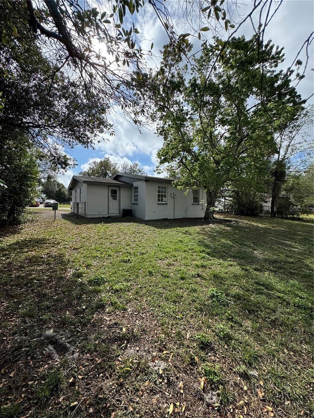 rear view of house with a lawn