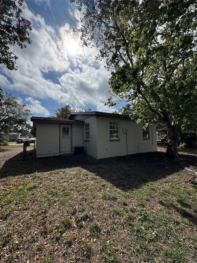 rear view of property with a lawn