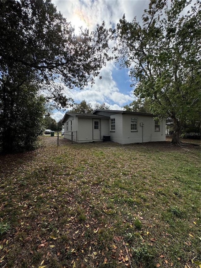 back of property featuring a lawn