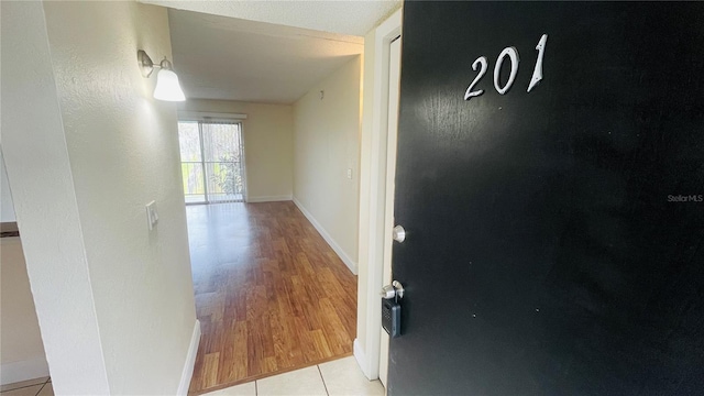 hallway with light tile patterned floors