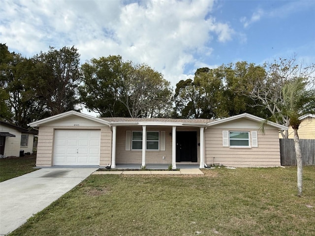 ranch-style home with a garage, covered porch, and a front lawn