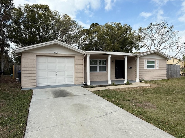 ranch-style house featuring a garage and a front yard