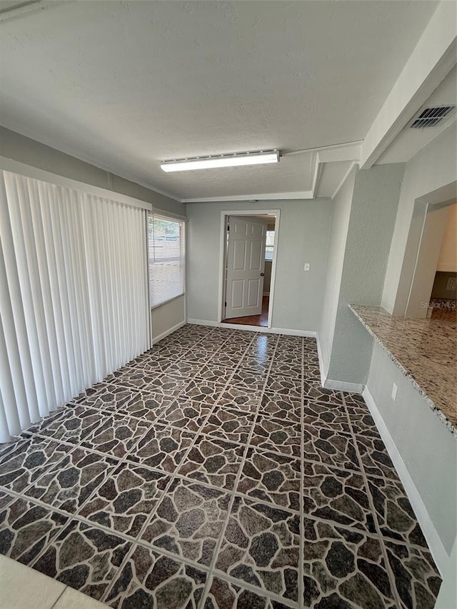 spare room featuring a textured ceiling