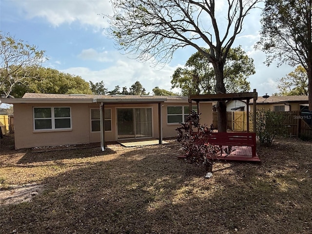 back of property featuring a wooden deck