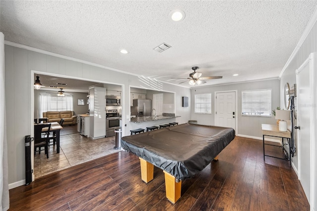 game room with wood-type flooring, plenty of natural light, pool table, and crown molding