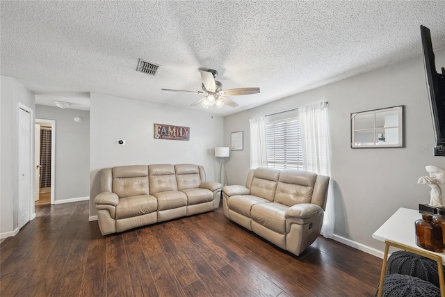 living room with ceiling fan, dark hardwood / wood-style floors, and a textured ceiling