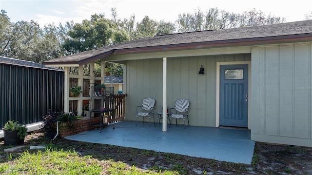 view of exterior entry with a patio