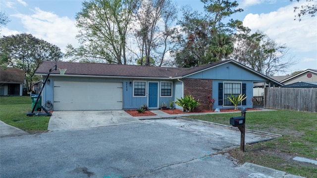 ranch-style house with a garage and a front lawn