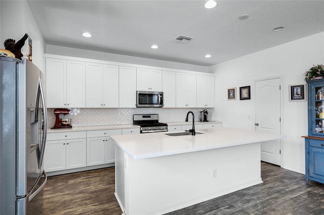 14214 Shocklach Dr, Winter Garden, FL 34787 - kitchen featuring decorative backsplash, dark wood finished floors, a sink, white cabinets, and stainless steel appliances