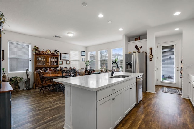 14214 Shocklach Dr, Winter Garden, FL 34787 - kitchen with visible vents, dishwasher, a sink, light countertops, and dark wood-style floors
