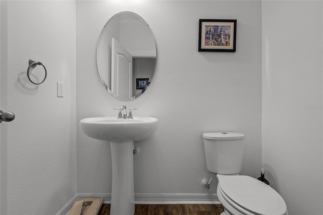 14214 Shocklach Dr, Winter Garden, FL 34787 - bathroom with baseboards, wood finished floors, and toilet