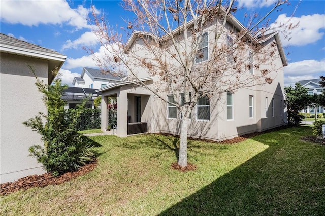 14214 Shocklach Dr, Winter Garden, FL 34787 - back of house featuring a lawn and stucco siding