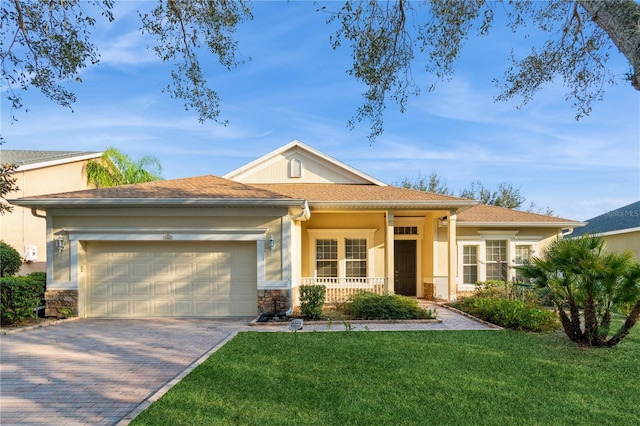 view of front of house featuring a porch, a garage, and a front lawn