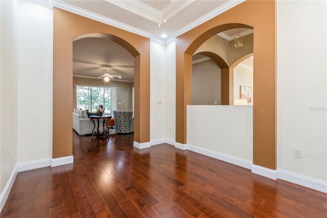 empty room with ornamental molding, ceiling fan, and dark hardwood / wood-style flooring