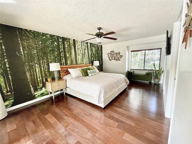 bedroom featuring ceiling fan, a textured ceiling, and wood finished floors