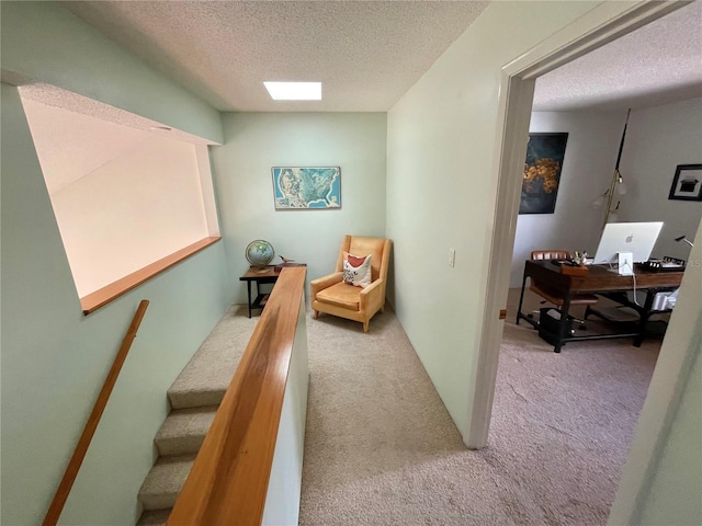 interior space with stairway, carpet, and a textured ceiling