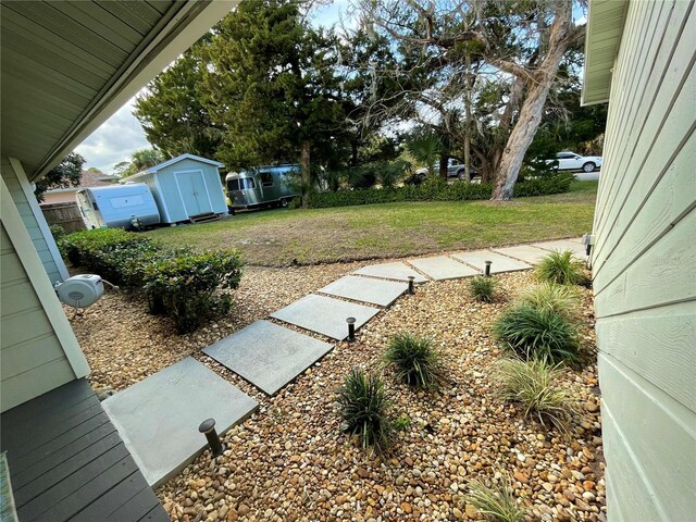 view of yard featuring a storage unit and an outdoor structure