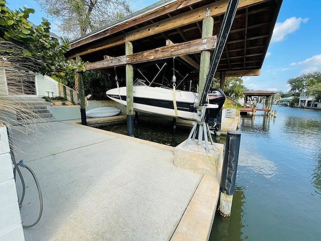 view of dock with a water view and boat lift