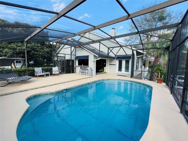 pool featuring a patio, french doors, and a lanai