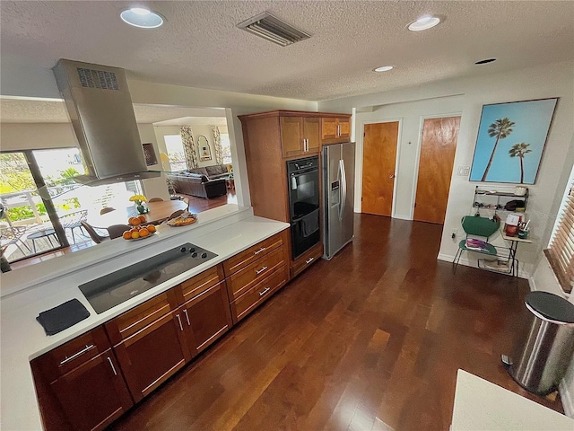 kitchen featuring dark wood finished floors, light countertops, visible vents, black appliances, and exhaust hood