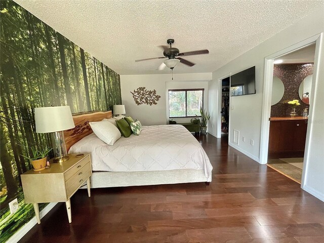 bedroom with visible vents, ceiling fan, a textured ceiling, wood finished floors, and baseboards