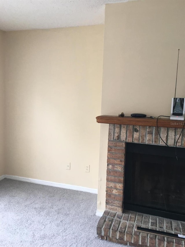 room details with carpet, a brick fireplace, and a textured ceiling