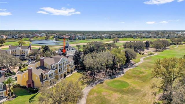 drone / aerial view with a residential view, view of golf course, and a water view