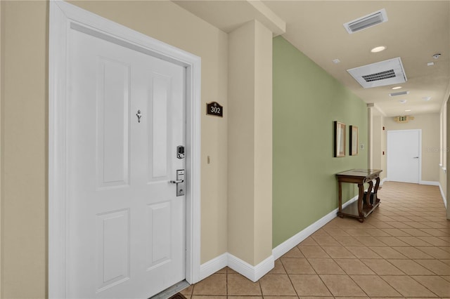 entrance to property featuring a porch and visible vents