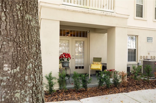 property entrance with a balcony and central AC