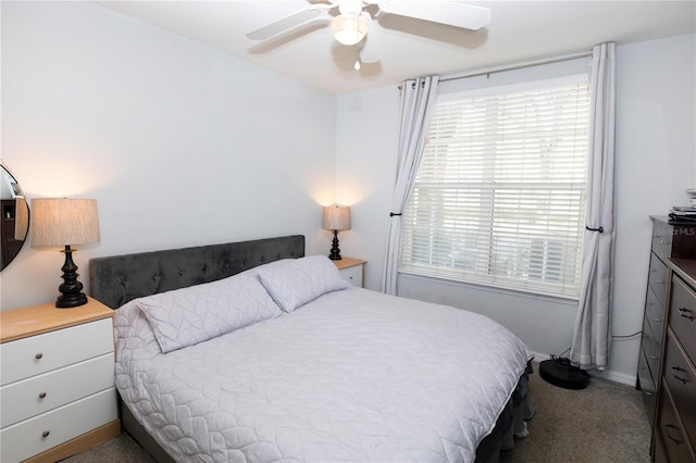 carpeted bedroom featuring ceiling fan and multiple windows