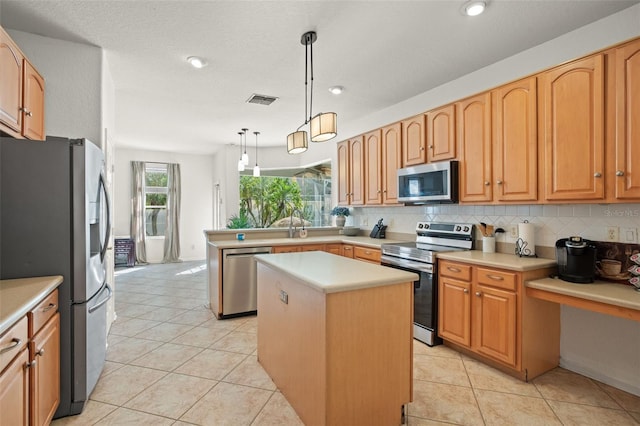 kitchen featuring a center island, hanging light fixtures, light tile patterned floors, appliances with stainless steel finishes, and decorative backsplash