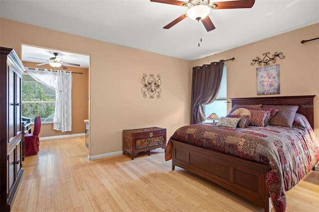 bedroom with light hardwood / wood-style floors and ceiling fan