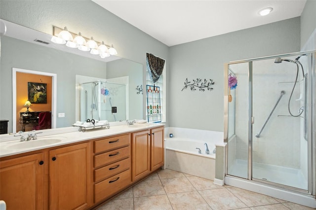 bathroom with tile patterned flooring, vanity, and independent shower and bath