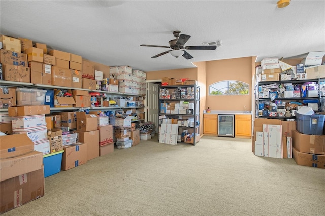 storage room featuring ceiling fan and beverage cooler