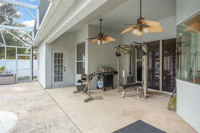 view of patio / terrace featuring a lanai, area for grilling, and ceiling fan