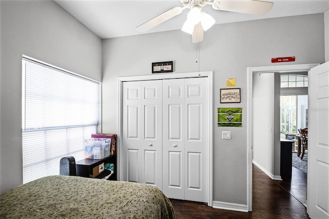 bedroom with a closet, dark hardwood / wood-style floors, and ceiling fan