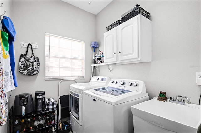 laundry room featuring sink, cabinets, and washing machine and clothes dryer