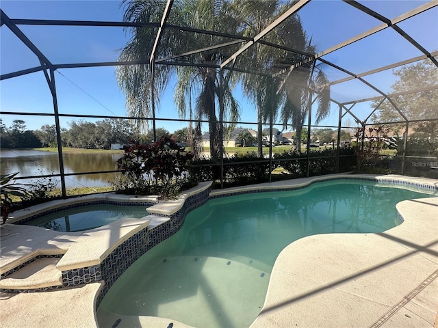 view of pool featuring a pool with connected hot tub, glass enclosure, and a water view