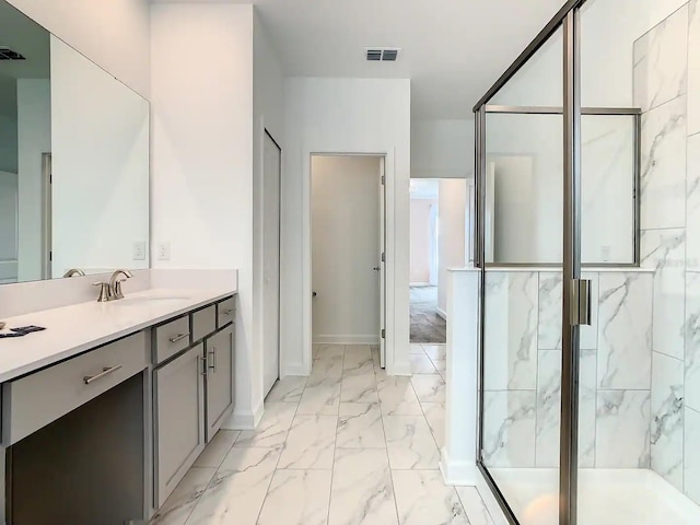 bathroom featuring vanity and an enclosed shower