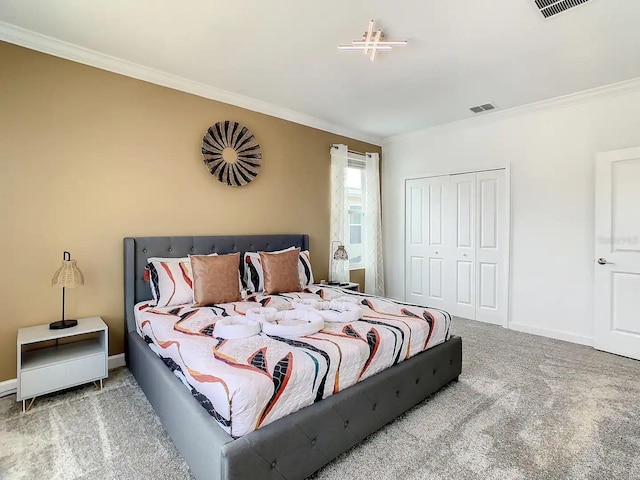 bedroom featuring ornamental molding, a closet, and carpet flooring