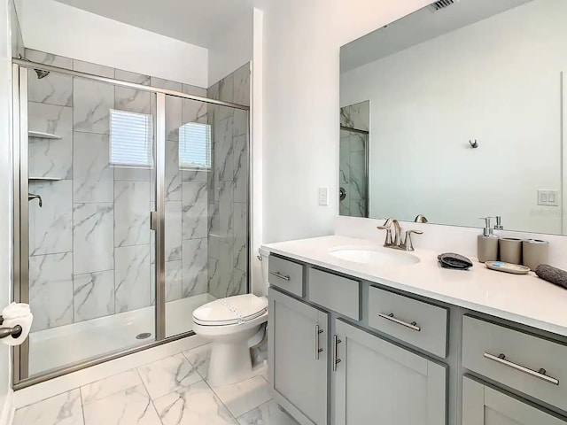 bathroom featuring a shower with door, vanity, and toilet