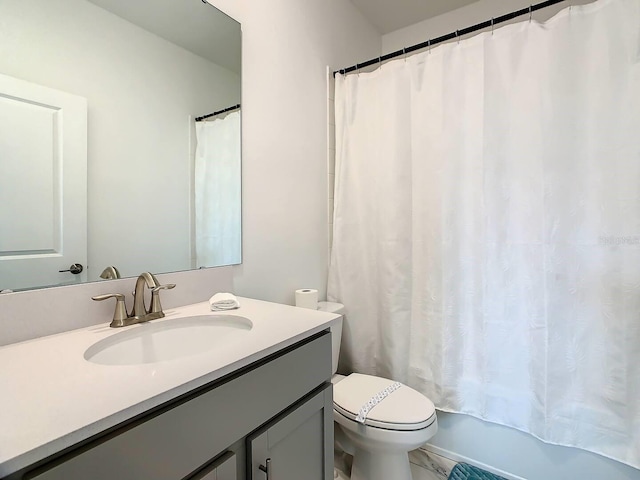 full bathroom with vanity, shower / tub combo, and toilet